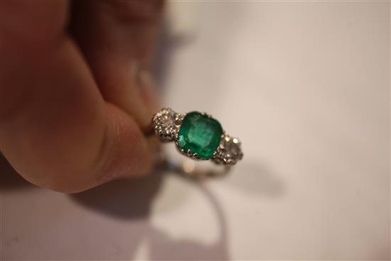 A mid 20th century 18ct white gold, emerald and diamond three stone ring, size K.